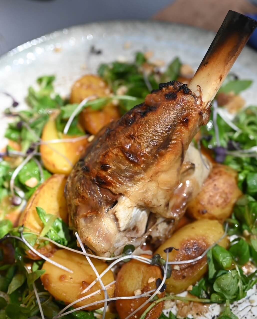 Slow-cooked aged lamb shank under the bell
